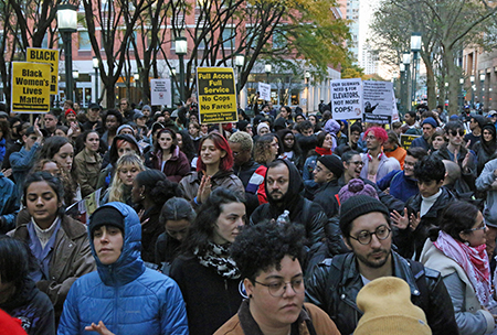 Hundreds descended on Metrotech Plaza demanding an end to overly aggressive police conduct. “About six of them or eight of them were on top of him. One put his knee in his neck. He kept saying, ‘I can’t breathe, I can’t breathe,’ and they would not let up. They handcuffed him. Slammed him into a sign.” Photo: Lem Peterkin