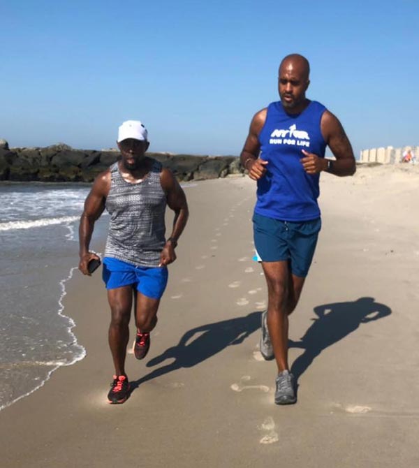 Patrick Burnett, left, with Marlon on training run at the beach.