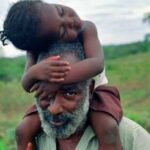 Pg11_David-with-girl-on-shoulders-455×283