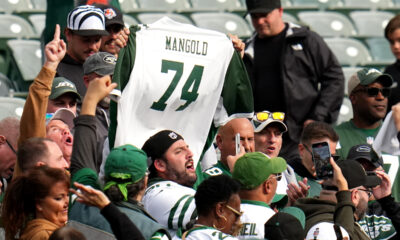 CINCINNATI, OHIO - OCTOBER 26: New York Jets fans hold up a Nick Mangold jersey after the game against the Cincinnati Bengals at Paycor Stadium on October 26, 2025 in Cincinnati, Ohio. (Photo by Dylan Buell/Getty Images)